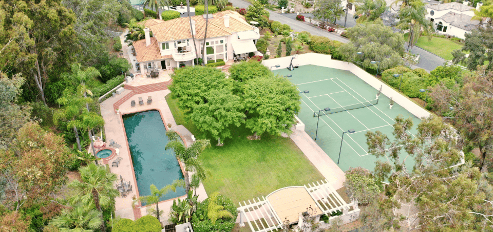 aerial view of aton center home with pool and tennis court
