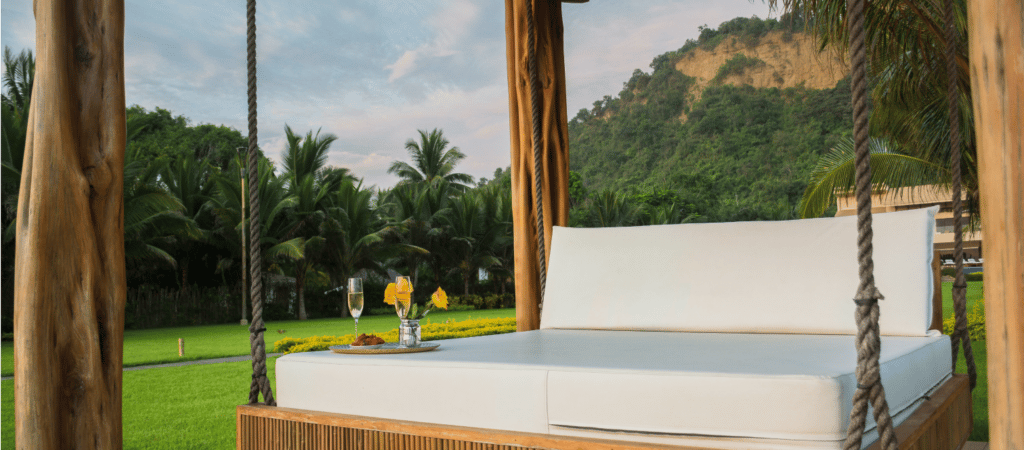 a suspended seat in a covered area amongst the hills