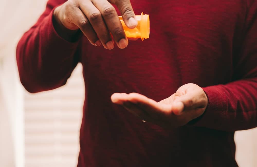 Man taking pills to find out how long does OxyContin last