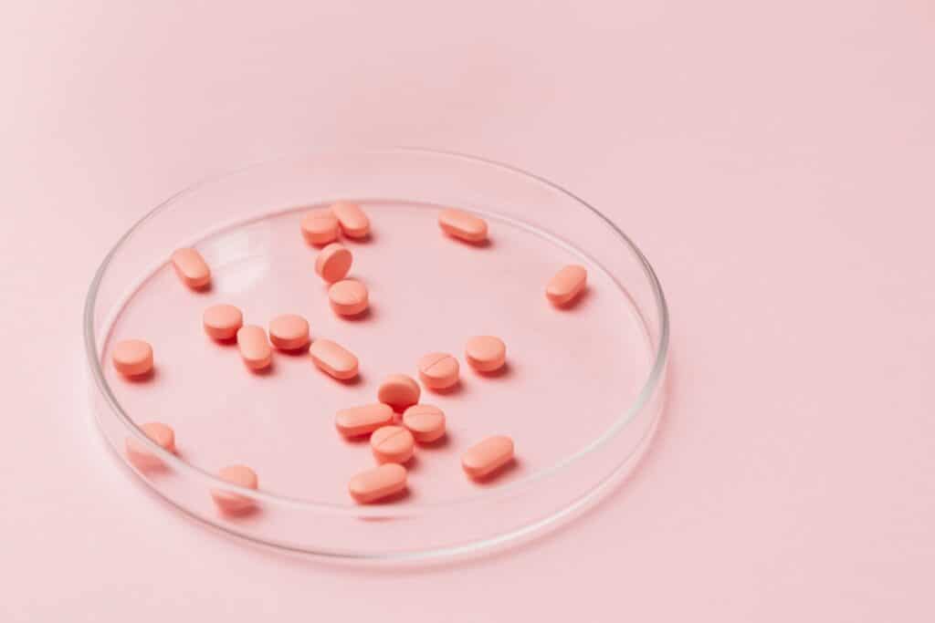 Pink pills in container