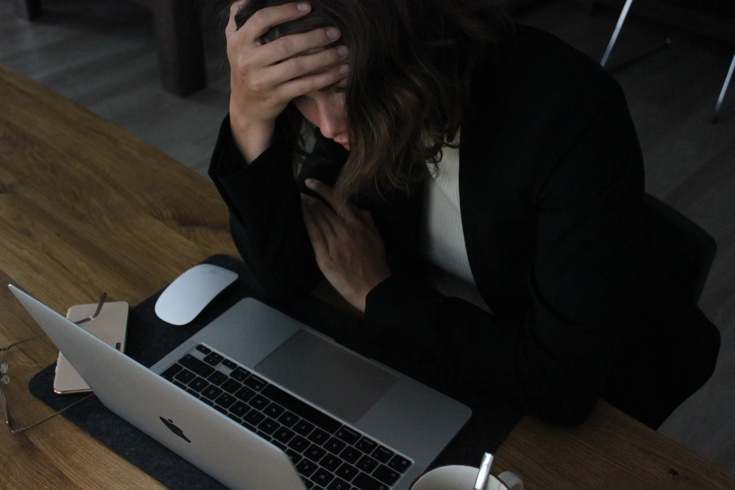businesswoman stressed out looking at her laptop