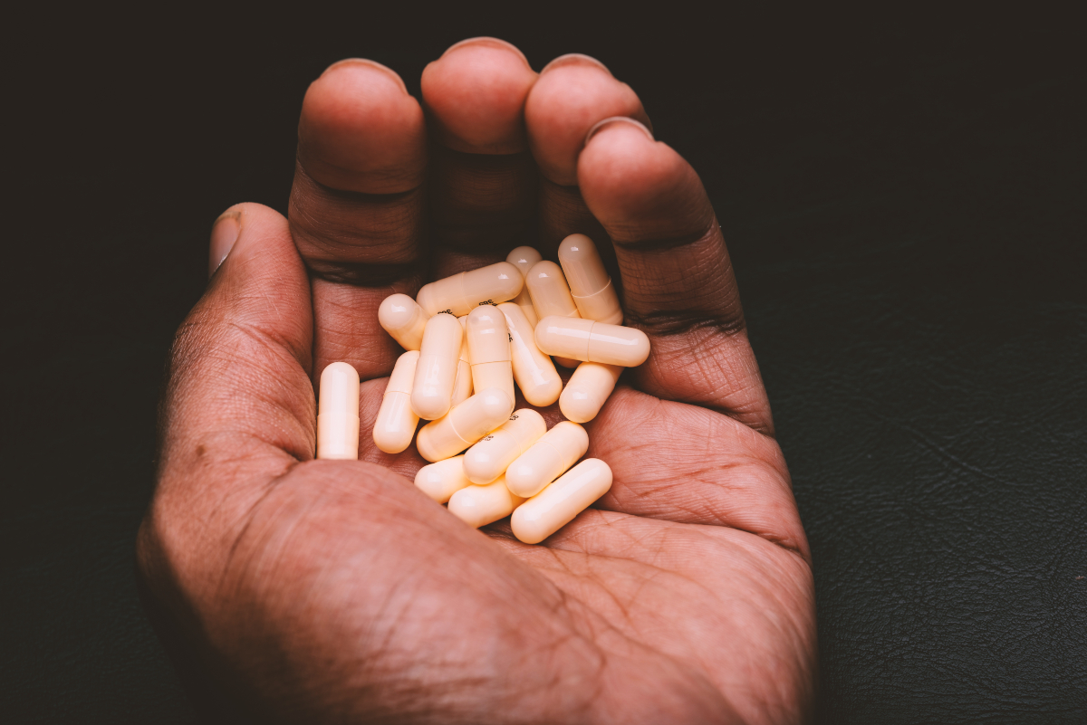 Man holding anxiety pills in his hand and they are benzodiazpines